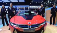 Thai models pose next to a BMW i8 car during the Motor Expo 2016 in Bangkok yesterday.