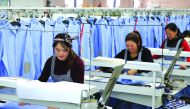 Women work in a shirt factory in Nantong, in China's Jiangsu province, yesterday.  China's manufacturing activity growth accelerated in November, official data showed.