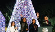 President Barack Obama (right), joined by First Lady Michelle Obama (second left), their daughter Sasha (second right) and celebrity Eva Longoria, react after pressing a button to light the National Christmas Tree in Washington, yesterday.