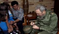 In this TV grab from a Cuban State Council video released December 2, 2016, the late Cuban leader Fidel Castro is seen with Argentine football legend Diego Armando Maradona and his daughters in Havana on December 29, 2002. The former president died on Nov