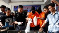 File Photo: Authorities at police headquarters in Jakarta, Indonesia, force recently arrested drug traffickers to help them destroy a huge haul of methamphetamin. / Reuters.