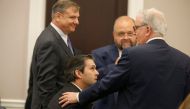 Defense attorneys Don McCune (L), Andy Savage and Miller Shealy surround former North Charleston police officer Michael Slager after a note was sent by the jury as they continue to deliberate at the Charleston County court in Charleston, South Carolina, D