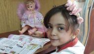 Bana al-Abed, seven, reading in her home in east Aleppo CREDIT: TWITTER
