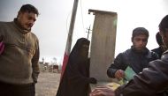Iraqis wait to get official documents outside the Qayyarah tribunal, in the town on the Tigris river south of the city of Mosul on December 6, 2016. AFP / Gailan Haji
