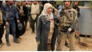 Miaad Madaad, the only female member of the Lions of the Tigris, a group of Sunni Arab fighters and part of PMU poses during a pause in a military operation against ISIS in Shayyalah al-Imam, Iraq November 30, 2016. (Reuters)