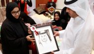  The Prime Minister and Minister of Interior H E Sheikh Abdullah bin Nasser bin Khalifa Al Thani presented an art work by one of the participants. Pic. by Qassim Rahmatullah