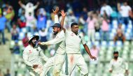 Indian skipper Virat Kohli (centre) celebrates with Ravichandran Ashwin (right) after Jennings' dismissal.