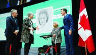 Canada's Finance Minister Bill Morneau (right) stands with Wanda Robson after her sister and rights activist Viola Desmond was chosen to be featured on a new $10 bank note during a ceremony at the Museum of History with Governor of Bank of Canada Stephen 