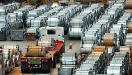 A truck drives past rolls of steel inside the China Steel Corporation factory, in Kaohsiung, southern Taiwan.