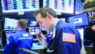 Traders work on the floor of the New York Stock Exchange .