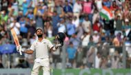 India's captain Virat Kohli celebrates after scoring a century (100 runs) during the third day of the fourth Test cricket match between India and England at the Wankhede stadium in Mumbai on December 10, 2016. (AFP / Punit PARANJPE)