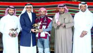 The winner of the 120km CEI** event, Hamad Towaim Al Marri receives the trophy from Minister of Culture and Sports H E Salah bin Ghanem Al Ali.