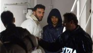 (FILES) This file photo taken on April 20, 2015 shows two men, identified as Mohammed Ali Malek (2nd L).  AFP / ALBERTO PIZZOLI
