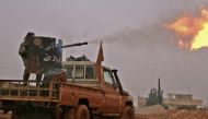 Syrian opposition fighters fire towards positions held by Islamic State (IS) group jihadists in al-Bab on the northeastern outskirts of the northern embattled city of Aleppo on December 13, 2016. / AFP / Saleh ABO GHALOUN
