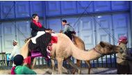 A child enjoys a camel ride at the ladies tent set up at Darb El Saai. 
