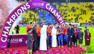 Akbar Al Baker, Group Chief Executive of Qatar Airways, presenting 18 carat gold cup, specially commissioned for the game, to FC Barcelona captain Andres Iniesta at Al Gharafa stadium yesterday. Barcelona defeated Al Ahli of Saudi Arabia 5-3 in the friend
