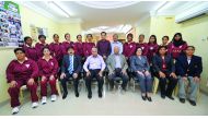 The Qatar Women's cricket team poses for a photograph with Qatar Cricket Association officials prior to their departure to UAE. 