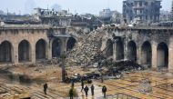 A general view shows Syrian pro-government forces walking in the ancient Umayyad mosque in the old city of Aleppo on December 13, 2016, after they captured the area. After weeks of heavy fighting, regime forces were poised to take full control of Aleppo, 