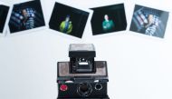 A photo illustration view of an old Polaroid Camera and some instant films are seen on December 12, 2016 In Los Angeles, California. At a photography studio in Cleveland, instructor Nicole Follen is trying to convince her students to step back in time and
