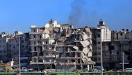 Buses which will be used to evacuate rebel fighters and their families from rebel-held areas of Aleppo are seen waiting on December 15, 2016.  AFP / Youssef KARWASHAN
