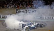 (FILES) This file photo taken on November 27, 2016 shows Mercedes AMG Petronas F1 Team's German driver Nico Rosberg celebrating at the end of the Abu Dhabi Formula One Grand Prix at the Yas Marina circuit.  AFP / MOHAMMED AL-SHAIKH
