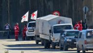 Staff from the International Red Cross and from the Syrian Red Crescent are seen in embattled city of Aleppo as efforts were underway to evacuate rebel fighters and their families from rebel-held areas on December 15, 2016.  AFP / STRINGER