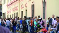 People queue outside Venezuela's Central Bank (BCV) in Caracas in an attempt to change 100 bolivar notes, yesterday.
