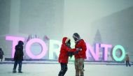 A couple skates during a snowstorm on an outdoor rink at city hall in Toronto, Canada, yesterday.