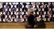 A woman passes by photos of EgyptAir flight 804 victims at the Cairo Opera House, May 26, 2016 (REUTERS / Mohamed Abd El Ghany) 