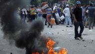 People carry goods taken from a food wholesaler after it was broken into, in La Fria, Venezuela December 17, 2016. REUTERS/Carlos Eduardo Ramirez
