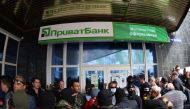 (FILES) This file photo taken on April 28, 2014 in the eastern Ukrainian city of Donetsk shows Pro-Russian militiants attacking a branch of Ukrainian bank Privatbank. Ukraine on December 18, 2016 nationalised the country's biggest bank in a bid to avert a