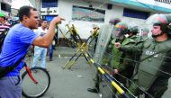 People confront Bolivarian National Guard member while attempting to cross the Francisco de Paula Santander international bridge, linking Urena, in Venezuela and Cucuta, in Colombia, despite the border closing order issued by the Venezuelan government.