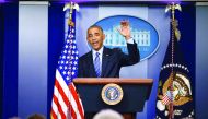 US President Barack Obama waves good bye at the conclusion of his last news conference of the year at the White House before leaving for his annual Hawaiian Christmas holiday in Washington.