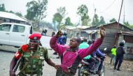 A man is arrested by a member of the military police after people attempted to block the road with rocks, in the neighbourhood of Majengo in Goma, eastern DR Congo, yesterday.