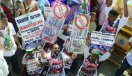 People hold placards of banned 500 and 1000 rupee notes during a protest against demonetisation, in Mumbai, yesterday. 