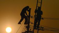 Workers adjust electricity cables set up temporarily on the banks of the River Ganges in Allahabad on December 19, 2016, in preparation for the annual Hindu religious fair of Magh Mela. The Magh Mela is held every year on the banks of Triveni Sangam - the