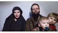 A still image from a video posted by the Taliban on social media on December 19, 2016 shows American Caitlan Coleman (L) speaking next to her Canadian husband Joshua Boyle and their two sons. Taliban/Social media via Reuters