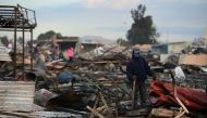 Firefighters work amid the debris left by a huge blast that occured in a fireworks market in Mexico City, on December 20, 2016 killing at least nine people and injuring 70, according to police. The conflagration, in the suburb of Tultepec, set off a quick