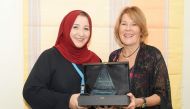 Hoda Salam Nakhla (left) and Deborah Nelson of Mental Health Service, HMC, with NDNQI award.