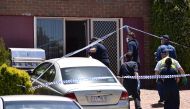 Police walk towards a door as they search a house in the Melbourne suburb of Meadow Heights, Australia, December 23, 2016 during an operation regarding a plot to attack prominent sites in central Melbourne with a series of bombs on Christmas Day that auth