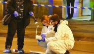 Italian Police officers work next to the body of Anis Amri in a suburb of the northern city of Milan