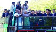 Asif Ali Zardari, former president of Pakistan and co-chairman of Pakistan People's Party (PPP), gestures to his supporters after returning from Dubai, at the Old Jinnah airport terminal in Karachi, yesterday.
