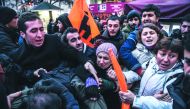 People scuffle as Turkish police detain protesters at Istiklal avenue in Istanbul, during a protest in reaction to a video released by the Islamic State group purportedly showing two captured Turkish soldiers being burned alive.