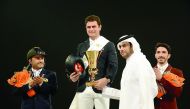 Turkish rider Derin Demirsoy, (centre) receives the trophy from QEF President Hamad Abdulrahman Al Attiyah after winning the QR 650,000 Grand Prix at the Qatar International Show Jumping Championship at the Qatar Equestrian Federation's (QEF) Main Arena o