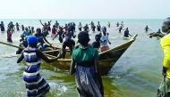 Survivors of a boat accident come back ashore on Lake Albert, in Buliisa, yesterday.