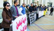 People demonstrate outside the Magistrate Court as Arab Israeli lawmaker Basel Ghattas undergoes a hearing, in Rishon Letzion, in central Israel, yesterday. Israeli police said they arrested an Arab lawmaker whose immunity has been lifted after he was sus
