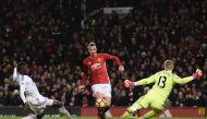 Manchester United's Swedish striker Zlatan Ibrahimovic (C) lifts the ball over Sunderland's English goalkeeper Jordan Pickford (R) to score their second goal during the English Premier League football match between Manchester United and Sunderland at Old 