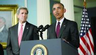 US President Barack Obama delivers a statement after meeting with the National Security Council, accompanied by US Secretary of State John Kerry (left) at the State Department in Washington, DC.