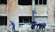 Syrian workers clean up the water station in Aleppo's Suleiman Al Halabi neighbourhood. 
