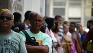 Public servants of Rio de Janeiro state queue outside their union building to receive food and other supplies donated by volunteers and colleagues as some of them haven't received their payment for several months, in Rio de Janeiro, Brazil on December 27,
